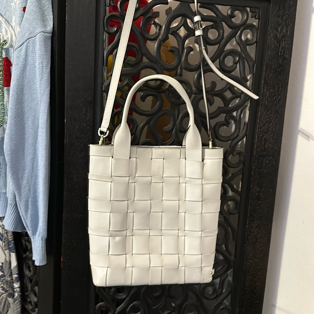 Lot of four Michael Kors handbags.